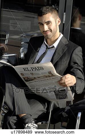 Stock Photo - Man reading newspaper in the sun. Fotosearch