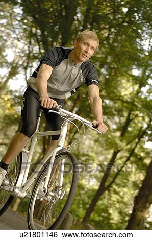 Stock Photograph - Man riding racing bicycle. Fotosearch