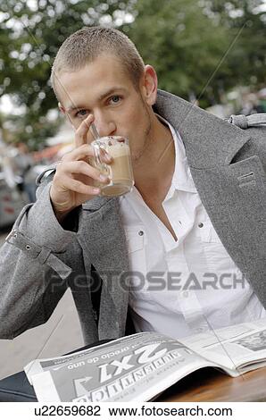 Stock Image - Man with coffee and newspaper. Fotosearch