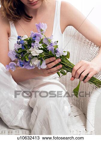 Model holding a bouquet of sweet pea and forget-me-not View Large Photo Image Stock Image - Model holding a bouquet of sweet pea and forget-me-not. Fotosearch