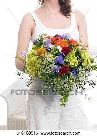 Stock Photography - Modell with a summery bouquet: roses, vetches, phlox and dill. Fotosearch