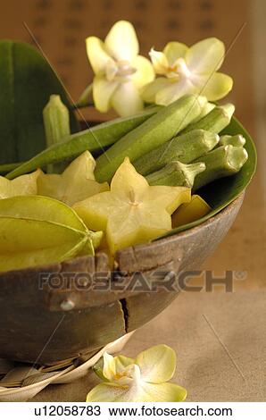 Stock Image - Orchid blossoms and carambola. Fotosearch