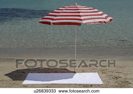 Stock Image - Parasol with red and white stripes. Fotosearch