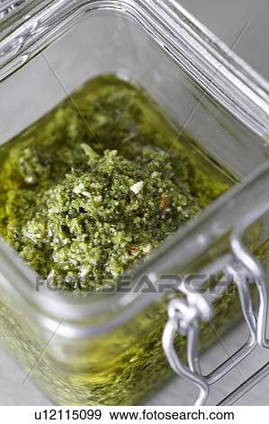 Stock Photo - Pesto in a jar. Fotosearch