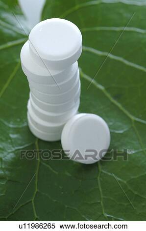 Stock Photography - Piled Schüßler tablets on a leaf. Fotosearch