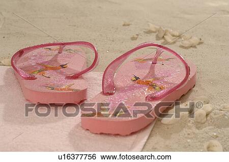 Pink flip flops in the sand View Large Photo Image Stock Photograph - Pink flip flops in the sand. Fotosearch
