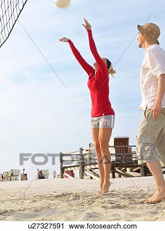 Stock Image - Playing beachvolleyball. Fotosearch