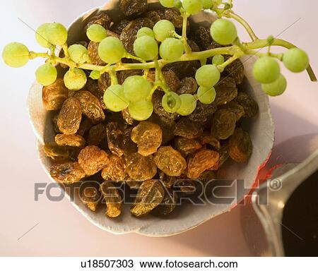 Stock Image - Raisins in a white bowl. Fotosearch
