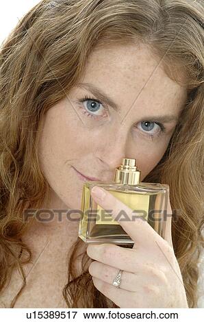 Redhead lady with parfume bottle View Large Photo Image Stock Photo - Redhead lady with parfume bottle. Fotosearch