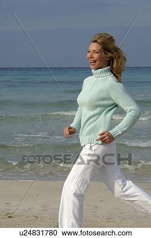 Running woman in turquoise pullover at the sea View Large Photo Image Stock Image - Running woman in turquoise pullover at the sea. Fotosearch