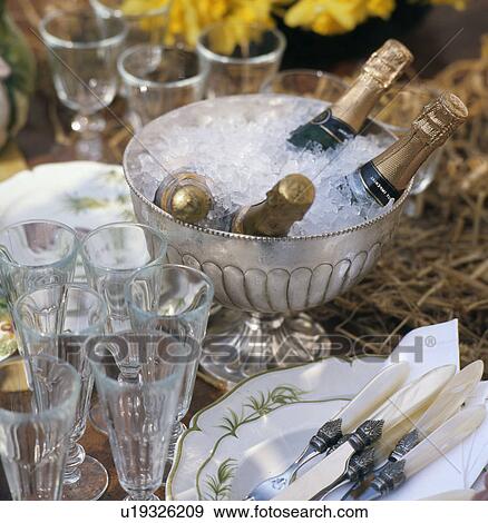 Stock Photo - Silver bowl with ice and champagne bottles. Fotosearch