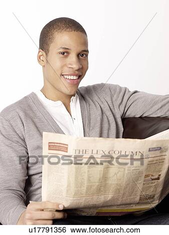 Stock Photograph - Smiling man reading newspaper. Fotosearch