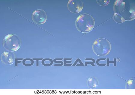 Stock Photo - Soap-bubbles in front of blue background. Fotosearch