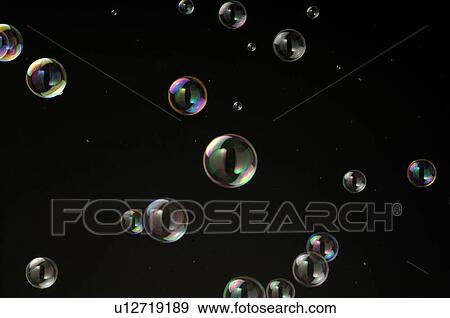 Stock Photo - Soap bubbles in front of dark background. Fotosearch
