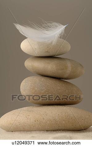 Stacked stones with a feather View Large Photo Image Stock Image - Stacked stones with a feather. Fotosearch