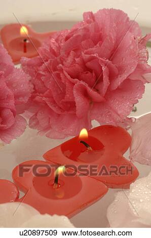 Swimming candles and blossoms in a bowl View Large Photo Image Stock Photo - Swimming candles and blossoms in a bowl. Fotosearch