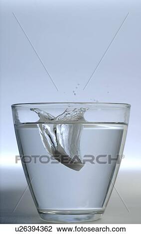 Stock Image - Tablet in glass of water. Fotosearch