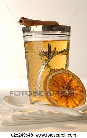 Stock Photo - Tea glass with cinnamon stick and orange slice. Fotosearch