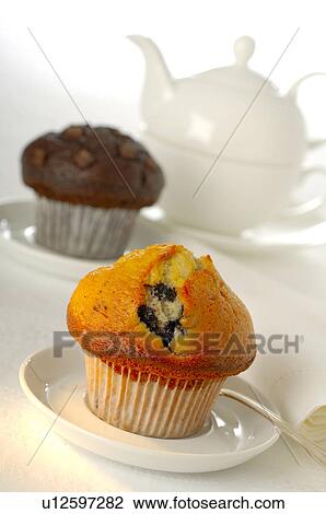 Stock Image - Tea pot and a muffin. Fotosearch