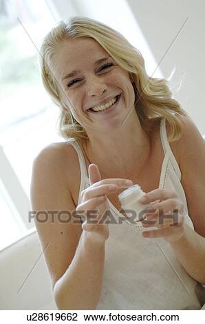Teenage girl applying creme View Large Photo Image Stock Image - Teenage girl applying creme. Fotosearch
