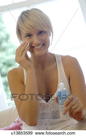 Stock Photo - Teenage girl applying facial cleanser. Fotosearch