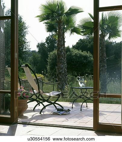 Stock Photograph - terrace with palms. Fotosearch