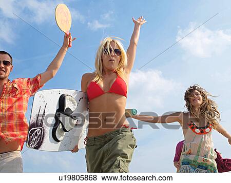 Three active participants at the seaside View Large Photo Image Stock Photo - Three active participants at the seaside. Fotosearch