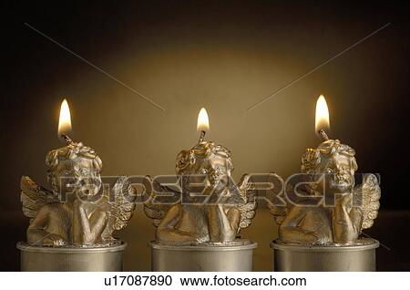 Three burning Christmas candles View Large Photo Image Stock Image - Three burning Christmas candles. Fotosearch