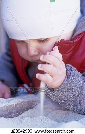 Stock Image - Toddler playing in the sand. Fotosearch