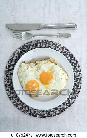 Two fried eggs on bread View Large Photo Image Stock Photo - Two fried eggs on bread. Fotosearch