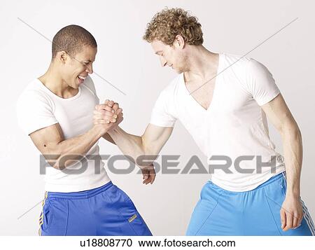Two friends arm wrestling View Large Photo Image Stock Image - Two friends arm wrestling. Fotosearch