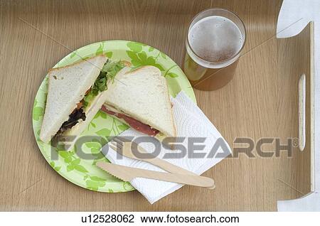 Stock Image - Two sandwiches and glass of beer. Fotosearch