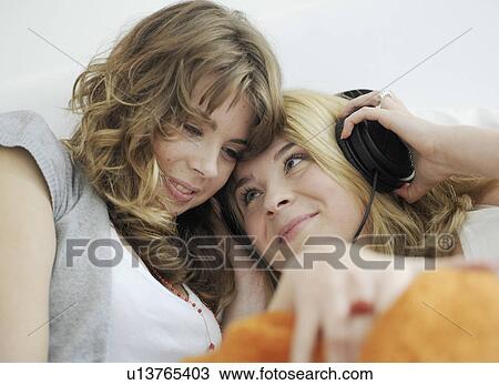 Two young women with headset View Large Photo Image Stock Image - Two young women with headset. Fotosearch