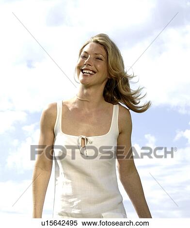 Stock Photography - White dressed woman under a blue sky. Fotosearch