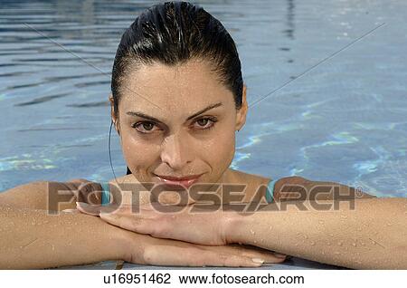 Stock Image - Woman at pool edge. Fotosearch