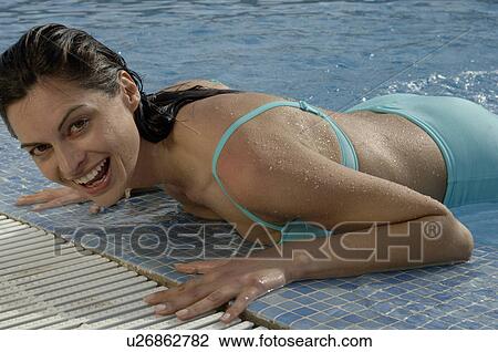 Woman at pool edge View Large Photo Image Stock Image - Woman at pool edge. Fotosearch