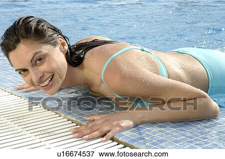Stock Photo - Woman at pool edge. Fotosearch