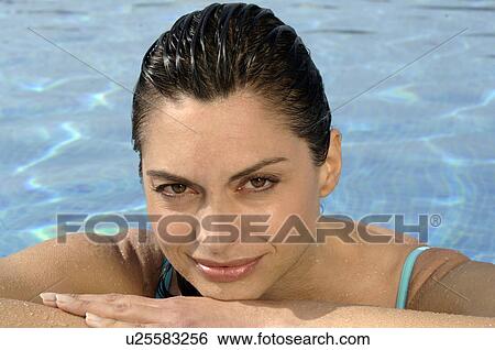 Stock Photograph - Woman at pool edge. Fotosearch