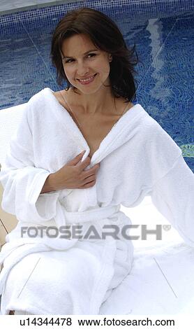 Stock Photo - Woman at the swimming pool in a bathrobe. Fotosearch