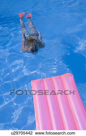 Woman diving in the water and a air mattress View Large Photo Image Stock Image - Woman diving in the water and a air mattress. Fotosearch