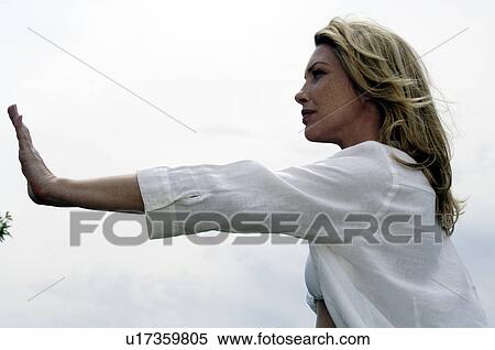 Stock Photography - Woman doing tai chi exercises. Fotosearch