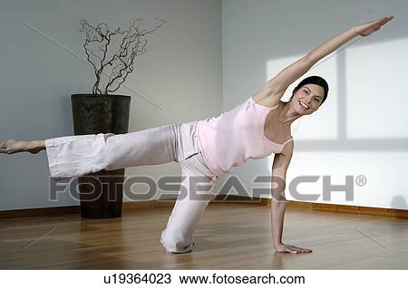 Woman doing yoga exercises View Large Photo Image Stock Image - Woman doing yoga exercises. Fotosearch