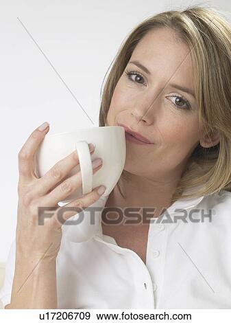 Woman drinking a cup of tea View Large Photo Image Stock Photo - Woman drinking a cup of tea. Fotosearch