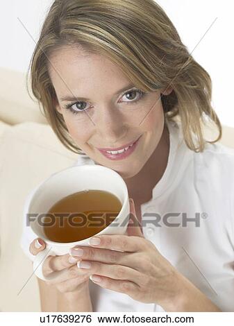 Woman drinking a cup of tea View Large Photo Image Stock Photograph - Woman drinking a cup of tea. Fotosearch