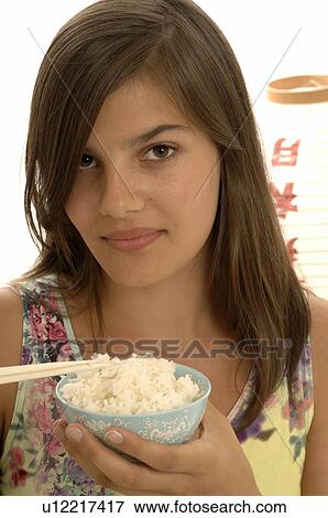 Woman eating rice with chopsticks View Large Photo Image Stock Photo - Woman eating rice with chopsticks. Fotosearch