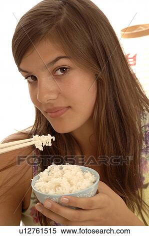 Woman eating rice with chopsticks View Large Photo Image Stock Photography - Woman eating rice with chopsticks. Fotosearch