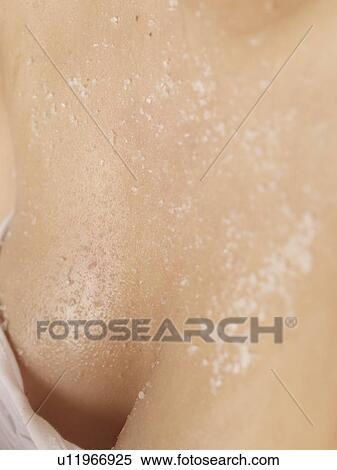 Woman having salt exfoliation on her cleavage View Large Photo Image Stock Photography - Woman having salt exfoliation on her cleavage. Fotosearch