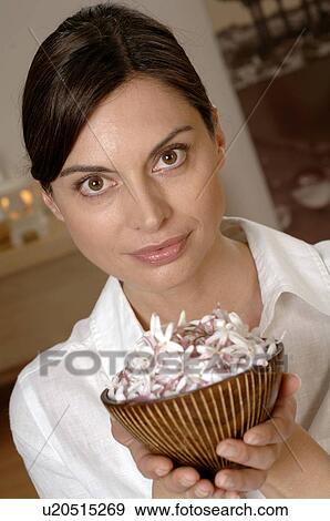 Woman holding a bowl filled with blossoms View Large Photo Image Stock Photo - Woman holding a bowl filled with blossoms. Fotosearch