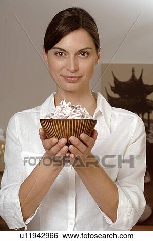 Woman holding a bowl filled with blossoms View Large Photo Image Stock Photograph - Woman holding a bowl filled with blossoms. Fotosearch