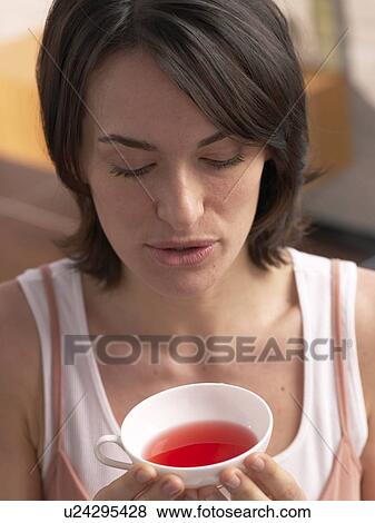 Stock Photo - Woman holding a cup of tea. Fotosearch